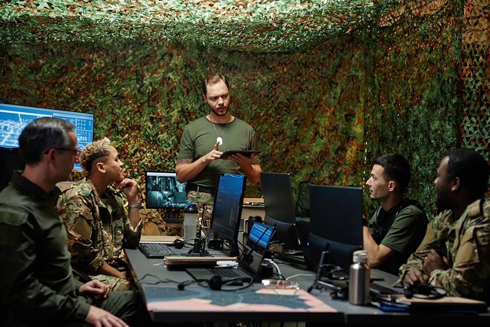 Young confident officer of surveillance room using tablet during report